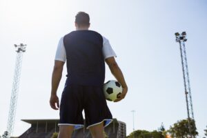 Soccer player standing with a ball